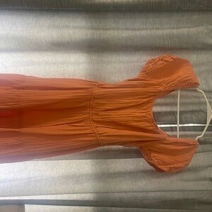 LINENE PASTEL ORANGE DRESS WITH OPEN BACK AND TIE DESIGN.